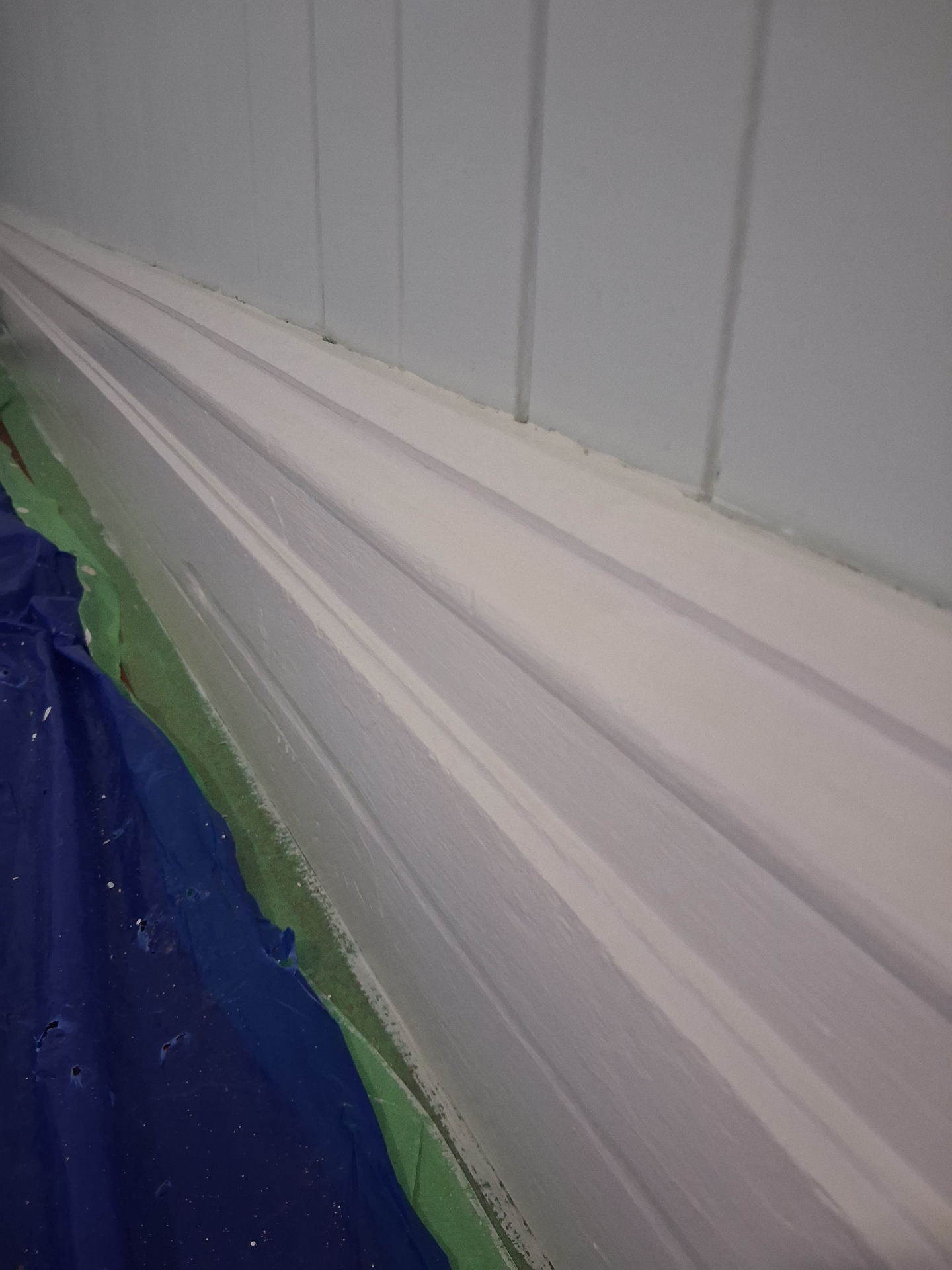 Freshly painted skirting board with crisp enamel finish